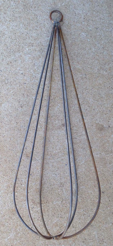 A solid steel decorative hanging object with a ring at the top and multiple curves throughout its structure, displayed against a neutral background.